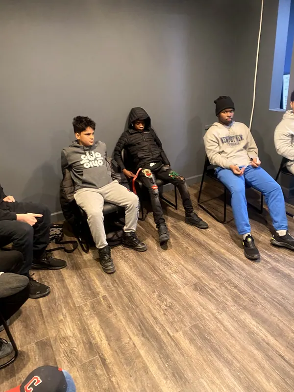 Boys seated around the room for a group talk.