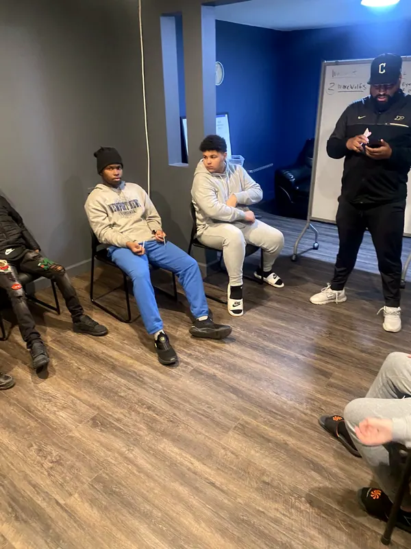 Boys and a mentor in a group session.