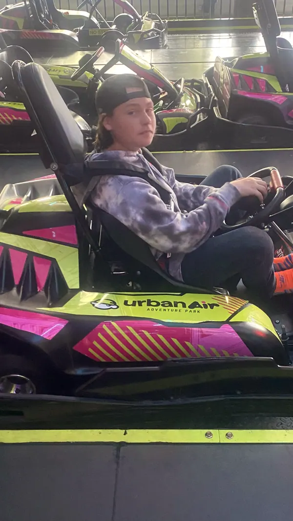 A boy driving a go-kart.