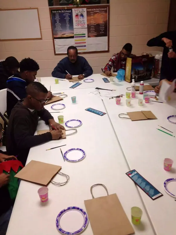 Boys at a long table during a lesson.