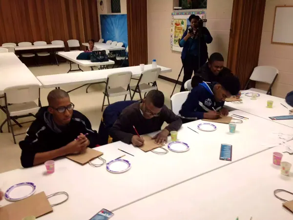 Boys at tables during a lesson.