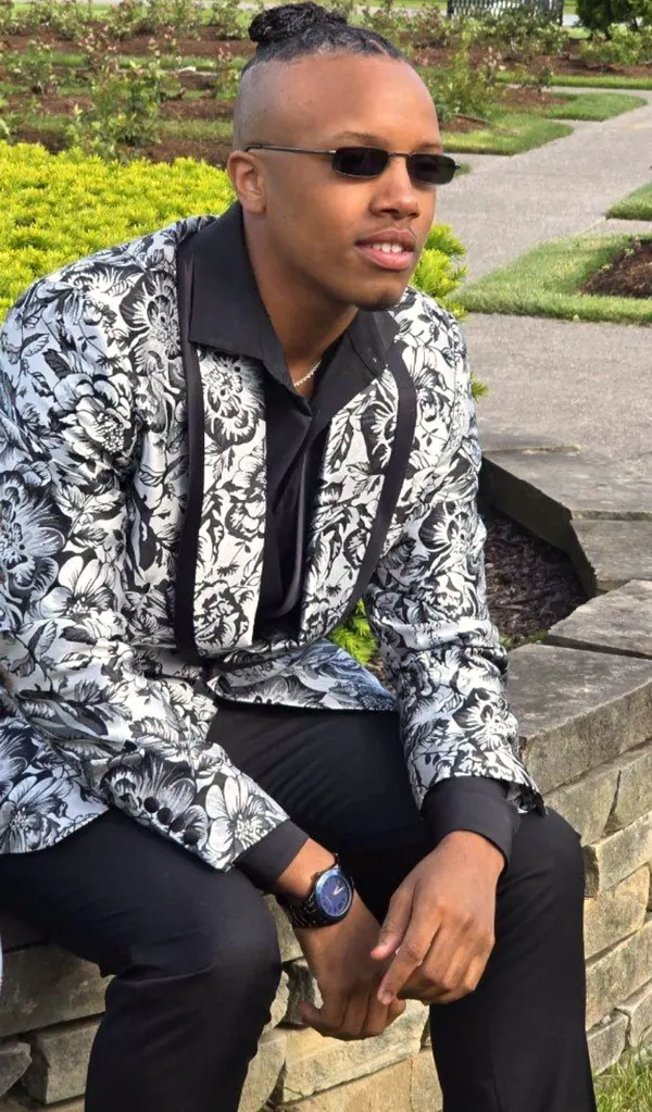 A young man in a sharp patterned jacket.