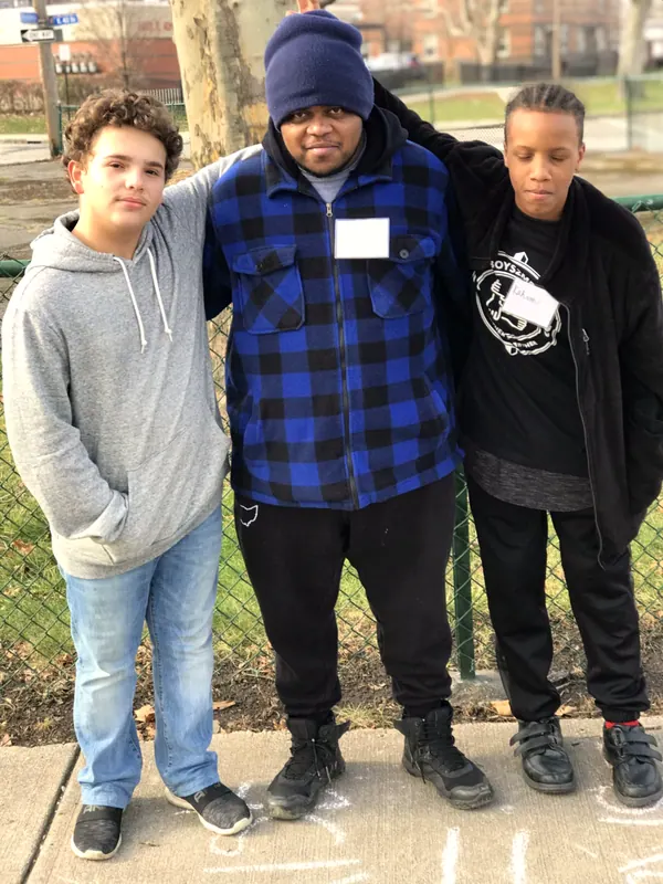 Three Boys2Men boys standing together outside.
