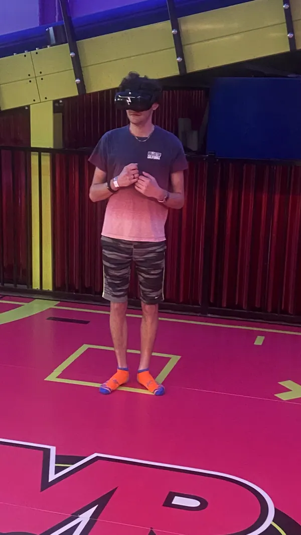 A boy trying virtual reality on a Boys2Men outing.